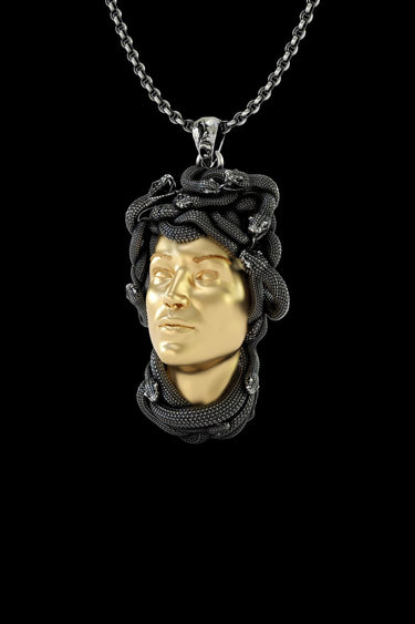 Close-up view of handcrafted Medusa pendant showing intricate serpent hair texture and two-tone finish detail