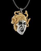 Close-up view of handcrafted Medusa pendant showing intricate serpentine hair details and dramatic facial expression