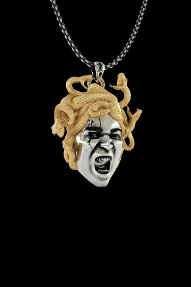 Close-up view of handcrafted Medusa pendant showing intricate serpentine hair details and dramatic facial expression
