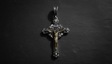 Rose gold plated 925 sterling silver crucifix pendant with INRI inscription on dark slate background