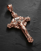 Yellow gold finish Catholic cross pendant showing detailed Jesus Christ figure and baroque scrollwork design