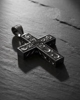 Close-up detail of ornate baroque cross pendant displaying masterful metalwork and sterling silver craftsmanship
