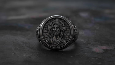 Side angle view of gothic Jesus ring showing black rhodium sterling silver band with religious iconography detailing