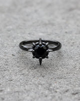 Gothic starburst ring with black stone showing detailed spike setting and sterling silver band construction