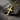 Angled view of a gold personalized cross necklace showing the custom 'Jessica' engraving and the delicate link chain.