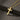 Personalized cross necklace in 18k gold vermeil with the name 'Jessica' engraved, resting on a dark textured stone.