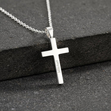 Sterling silver personalized cross necklace with 'Mitchell' engraved, showcasing the polished finish and classic design.