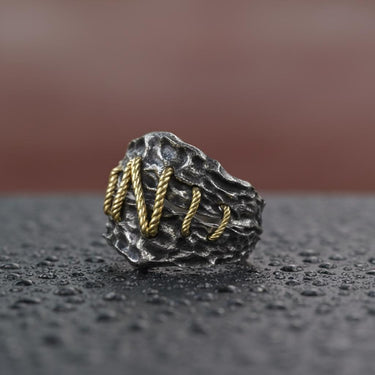 Side angle view of gothic monster stitch ring showing oxidized finish and two-tone design craftsmanship detail