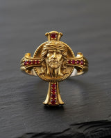 Gold vermeil Jesus cross ring with red gemstones and crown of thorns detail on black background