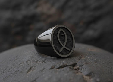 Close-up of Christian Ichthys symbol ring with textured surface and cross detail on black rhodium finish