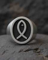 925 sterling silver Christian fish ring with Ichthys symbol and textured background displayed on dark stone surface