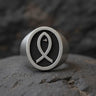 925 sterling silver Christian fish ring with Ichthys symbol and textured background displayed on dark stone surface