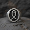 925 sterling silver Christian fish ring with black rhodium Ichthys symbol on textured background displayed on stone