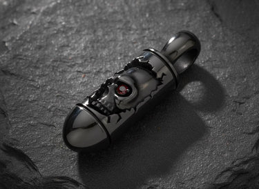 Gothic skull bullet pendant showing detailed weathered design and rhodium plating on natural slate