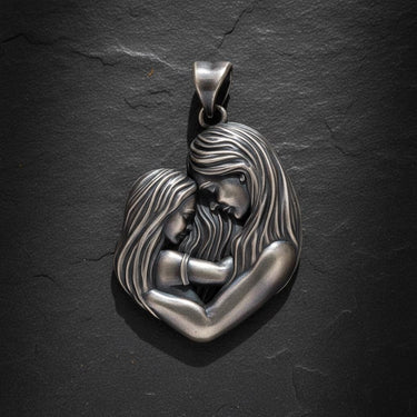925 sterling silver mother child pendant showing tender embrace with flowing hair details on dark slate background