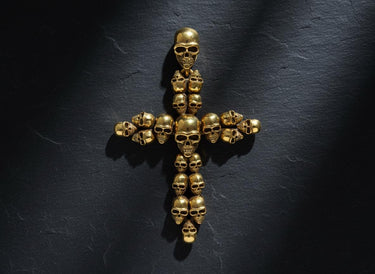 Gothic cross pendant showing intricate skull details and three-dimensional metalwork craftsmanship
