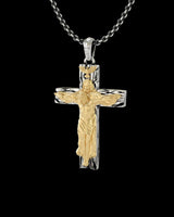 Angled view of the 925 sterling silver crucifix pendant, highlighting the detailed craftsmanship of the gold corpus and bail.