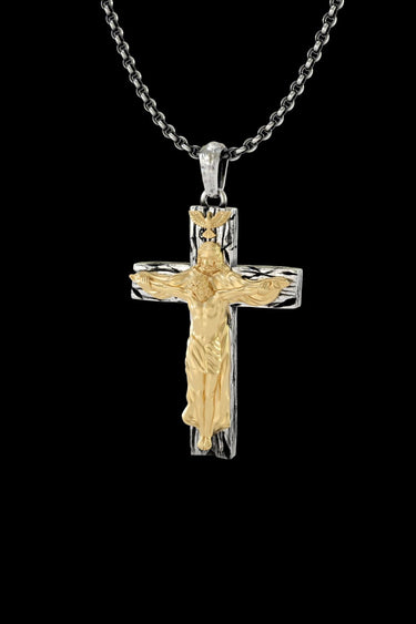 Angled view of the 925 sterling silver crucifix pendant, highlighting the detailed craftsmanship of the gold corpus and bail.