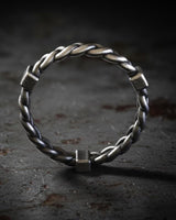 Side profile view of sterling silver twisted rope ring showing open adjustable band and intricate braided metalwork detail