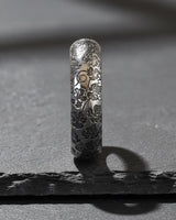 925 sterling silver nature ring with detailed leaf and twig engravings displayed on textured stone surface background