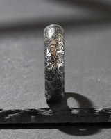 925 sterling silver nature ring with intricate leaf and twig engravings displayed on textured stone surface
