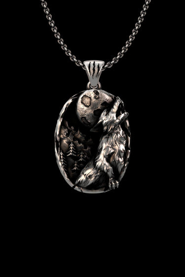 Silver wolf pendant featuring a 3D howling wolf and full moon, with an oxidized finish on a chain against a black background.