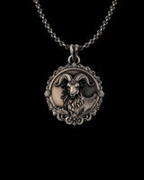 Silver Ram Pendant with oxidized finish, showing detailed horns and ornate filigree border on a sterling silver chain.