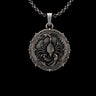 Detailed silver scorpion pendant with an oxidized finish, featuring a central scorpion and ornate gothic border on a chain.