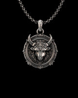 Silver Taurus pendant showcasing the detailed bull head and Victorian filigree border on an oxidized 925 sterling silver chain.