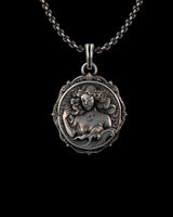 Silver Aquarius necklace featuring a detailed goddess figure surrounded by waves, hanging from a chain on a black background.
