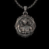 Silver Aquarius necklace featuring a detailed goddess figure surrounded by waves, hanging from a chain on a black background.