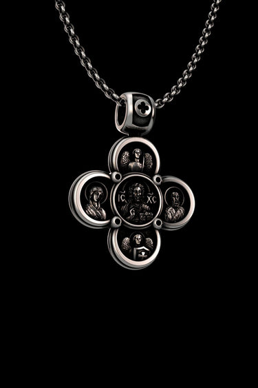 Angled view of the handcrafted Byzantine cross pendant in 925 sterling silver, showing the depth and detail of the icons.