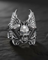 925 sterling silver skull engine ring with winged design displayed on dark wooden surface showing intricate details