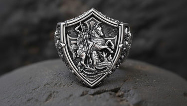 Sterling silver dragon signet ring with oxidized finish displaying intricate medieval craftsmanship and heraldic shield shape