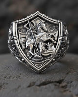 Close-up of St George knight defeating dragon on premium sterling silver signet ring with shield motif