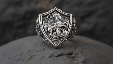 Close-up of St George knight defeating dragon on premium sterling silver signet ring with shield motif