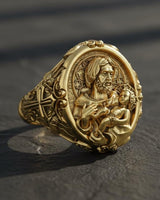 Close-up of sterling silver religious ring featuring Saint Joseph holding infant Jesus with ornate Catholic design details