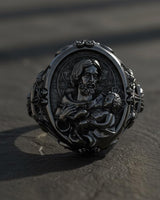 Detailed view of handcrafted Saint Joseph Catholic ring showing golden highlights and religious cross motifs on silver band