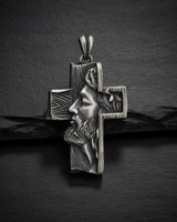 925 sterling silver Jesus cross pendant with detailed Christ profile and wood-grain texture on dark slate background