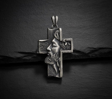 925 sterling silver Jesus cross pendant with detailed Christ profile and wood-grain texture on dark slate background