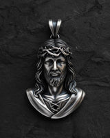 Gold-toned Jesus Christ pendant showing intricate facial features and crown of thorns religious design detail