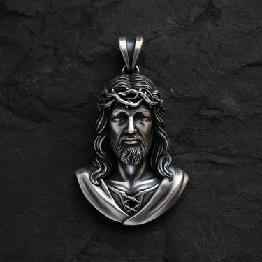 Gold-toned Jesus Christ pendant showing intricate facial features and crown of thorns religious design detail