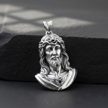 Close-up view of handcrafted Jesus pendant displaying sacred heart and flowing hair religious symbolism