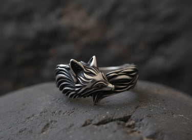 925 sterling silver fox ring with detailed flowing mane design displayed on textured stone surface background