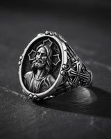 Side angle view of oxidized silver Jesus signet ring showing ornate Gothic border details and band thickness
