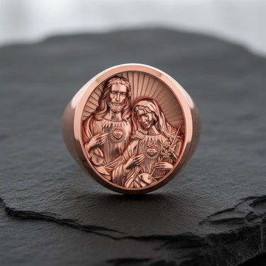 Sacred Hearts signet ring in rose gold showing detailed religious engravings of Jesus and Mary hearts