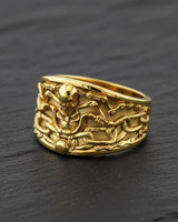 Side angle view of biker skull chain ring highlighting dimensional skull centerpiece and band thickness