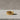 14K gold vermeil silver piston ring featuring engine cylinder design on concrete surface
