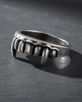 Angled view of the sterling silver Vampire Fangs Ring, highlighting the three-dimensional sculpting of the gothic teeth.