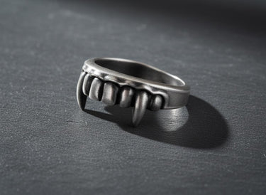 Angled view of the sterling silver Vampire Fangs Ring, highlighting the three-dimensional sculpting of the gothic teeth.